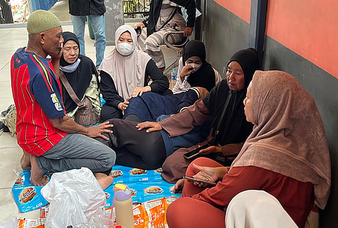 People wait for the news on their relatives who were among the passengers of the ferry that overturned in bad weather in the Java Sea on Sunday, in Banjarmasin, South Kalimantan, Indonesia, Monday, Sept. 14, 2026. 