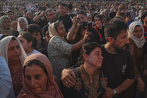 Mourners attend a mass funeral for prisoners who died in a fire that broke out during unrest at the local prison in the predominantly Kurdish city of Kobani, northern Syria.