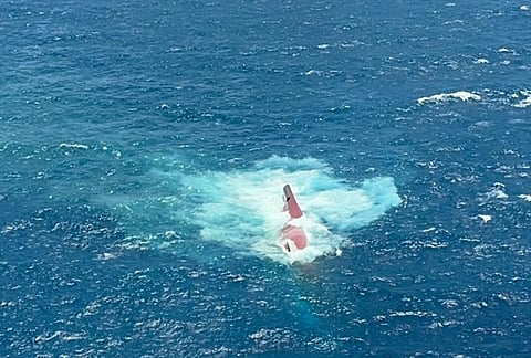 In this aerial photo released by Indonesia's National Search and Rescue Agency (BASARNAS), the keel of the Virgo Transport 8, a passenger ferry that overturned in bad weather on Sunday, is partially visible above the water in the Java Sea, Indonesia, Monday, Sept. 14, 2026. 