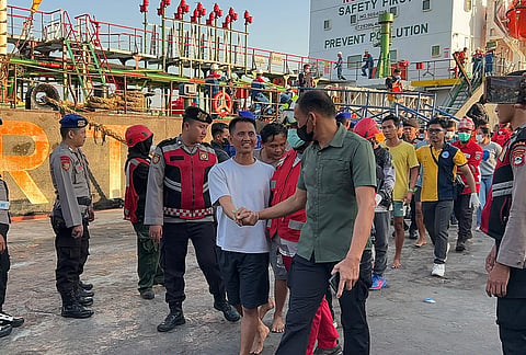 In this photo released by the Indonesia's National Search and Rescue Agency (BASARNAS), survivors from a passenger ferry overturned in bad weather in the Java Sea on Sunday are greeted by officials after disembarking a rescue ship in Banjarmasin, South Kalimantan, Monday, Sept. 14, 2026. 