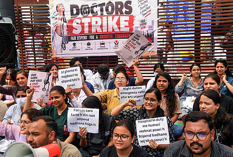 Doctors hold placards as they stage a protest outside the Outpatient Department (OPD) of Government Doon Medical College Hospital, demanding a stipend hike, in Dehradun, Uttarakhand.