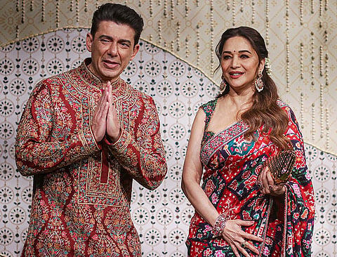 Bollywood actor Madhuri Dixit Nene, right, along with her husband during ‘Ganesh Chaturthi’ celebrations at the residence of Reliance Industries Chairman Mukesh Ambani, in Mumbai, Maharashtra.