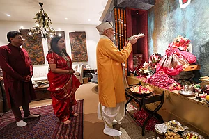| Photo: PMO via PTI : In this image received on Sept. 14, 2026, Prime Minister Narendra Modi performs a ritual as Union Minister Piyush Goyal and his wife look on during the PM's visit to Union Minister’s residence on ‘Ganesh Chaturthi’ festival, in New Delhi.