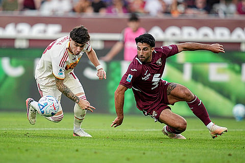 Roma's Matias Soule, left, and Torino's Eray Comert, right, challenge for the ball during the Serie A soccer match between FC Torino and AS Roma in Turin, Italy.