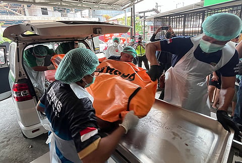 Staff remove the body of a victim of a passenger ferry that overturned in bad weather in the Java Sea from an ambulance upon arrival at a hospital in Banjarmasin, South Kalimantan, Indonesia, Tuesday, Sept. 15, 2026. 
