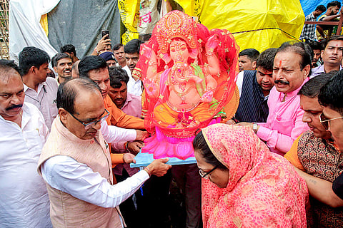 Union Minister Shivraj Singh Chouhan and wife Sadhna Singh carry an idol of Lord Ganesh during Ganesh Chaturthi festival, in Bhopal.