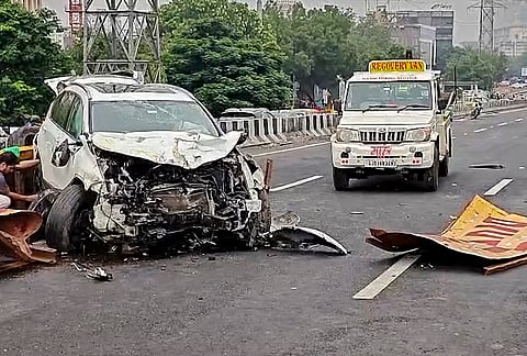Wreckage of a car is seen after it crashed and damaged several barricades on ISKCON Bridge, in Ahmedabad, Gujarat.
