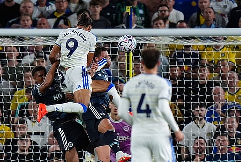 Leeds United's Dominic Calvert-Lewin, top, scores during the English Premier League soccer match between Leeds United and Newcastle United in Leeds, England, Monday Sept. 14, 2026. 