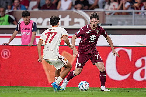 Roma's Emanuele Lulli, left, and Torino's Alessio Cacciamani, right, challenge for the ball during the Serie A soccer match between FC Torino and AS Roma in Turin, Italy.