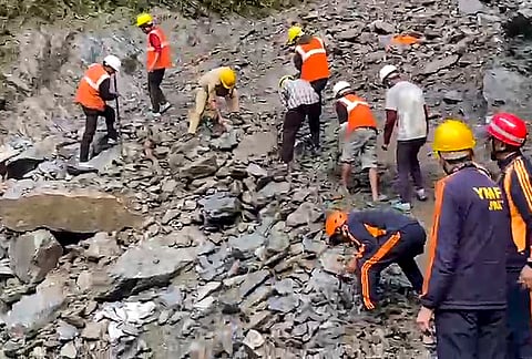 Rescue and disaster management personnel clear debris and boulders to restore the damaged Kedarnath pedestrian trek route following a landslide near the Chirbasa helipad, in Rudraprayag district, Uttarakhand.
