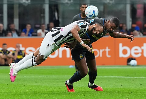 Udinese's Enzo Ebosse, left, challenges Inter Milan's Manuel Akanji during the Serie A soccer match between Inter Milan and Udinese in Milan, Italy, Monday, Sept. 14, 2026.