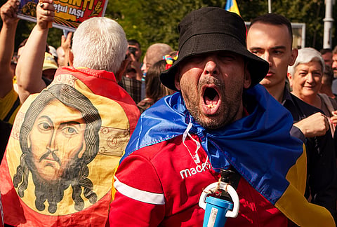 A demonstrator shouts slogans during a farmers' protest in Bucharest, Romania, Tuesday, Sept. 15, 2026. 