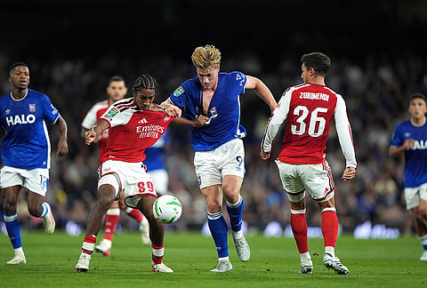 Arsenal's Marli Salmon, centre left, and Ipswich Town's Zian Flemming battle for the ball during the League Cup third round soccer match between Ipswich Town and Arsenal in Ipswich, England, Tuesday, Sept. 15, 2026.