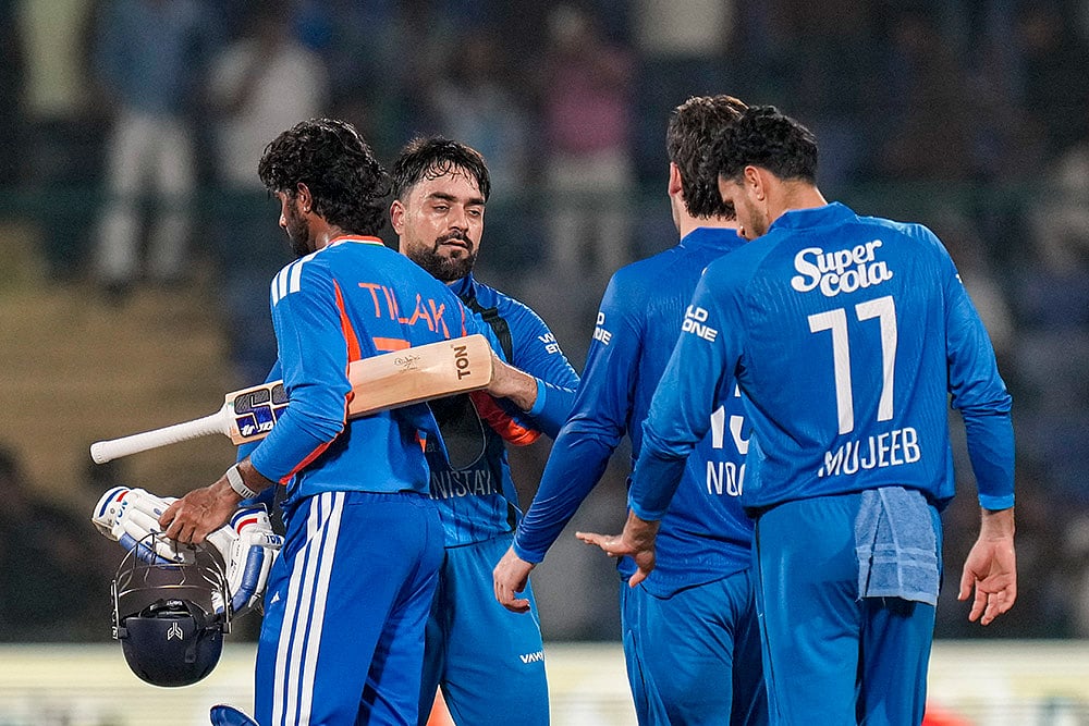 India's Tilak Verma greets Afghanistan's Rashid Khan after India wins the second T20I cricket match between India and Afghanistan, in New Delhi. - | Photo: PTI/Shahbaz Khan