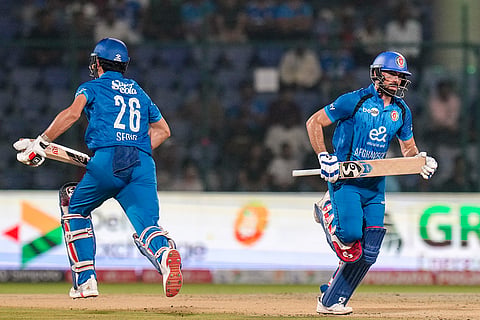 Afghanistan's Ibrahim Zadran, right, and Sediqullah Atal run between the wickets during the second T20I cricket match between India and Afghanistan, in New Delhi.