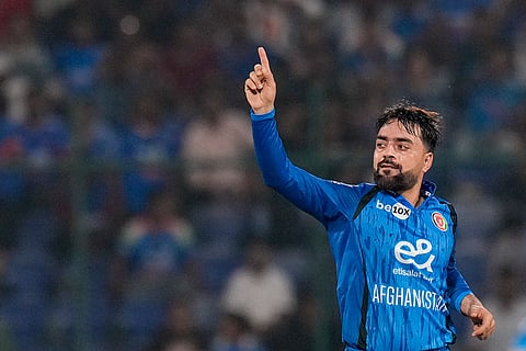 Afghanistan's Rashid Khan celebrates after taking the wicket of India's Shreyas Iyer during the second T20I cricket match between India and Afghanistan, in New Delhi.
