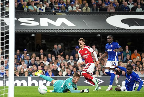 Arsenal's Max Dowman, centre, scores their side's third goal  during the League Cup third round soccer match between Ipswich Town and Arsenal in Ipswich, England, Tuesday, Sept. 15, 2026. 