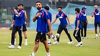 Varun Chakaravarthy Ruled Out Of Asian Games; BCCI Likely To Name DC All-Rounder As Replacement | Photo: PTI/Arun Sharma : India's Varun Chakaravarthy, front, during a practice session ahead of an ICC Men's T20 World Cup 2026 cricket match between India and Pakistan, at R Premadasa Stadium, in Colombo, Sri Lanka.