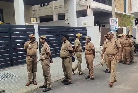 Police officials outside the residence of former Tamil Nadu school education minister Anbil Mahesh Poyyamozhi during a raid by Directorate of Vigilance and Anti-Corruption, in Tiruchirappalli.