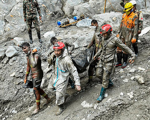 Nepal Army personnel recover a body during an ongoing joint and rescue operation from the tunnel of Chilime Hydropower Project following the devastating flash floods, in Rasuwa district, Nepal.