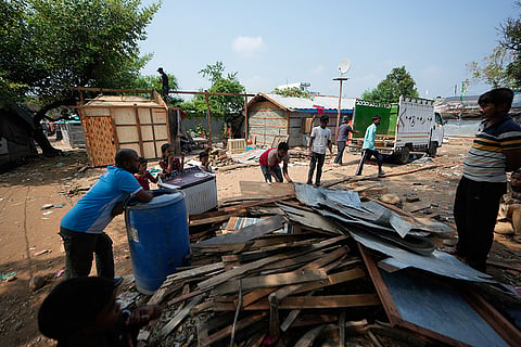 Rohingya refugees dismantle their homes following government notices ordering the removal of unauthorized structures in Jammu, India.