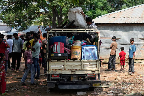 Rohingya refugees sit with their belongings on an auto-rickshaw following government notices ordering the removal of unauthorized structures in Jammu, India.