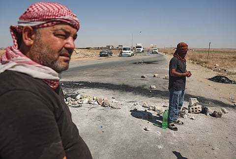 Local residents block a road to prevent oil tankers from the Rmeilan oil fields from passing during ongoing protests against higher fuel prices at the entrance to Tal Tamr, northeastern Syria, Wednesday, Sept. 16, 2026. 