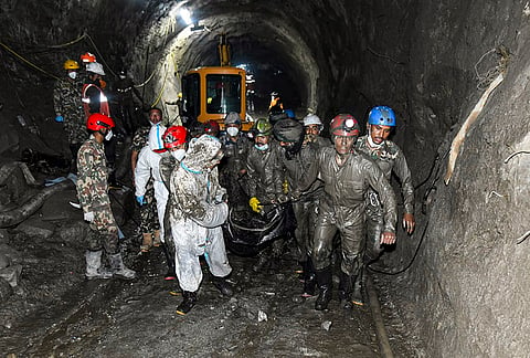 Nepal Army personnel recover a body during an ongoing joint and rescue operation from the tunnel of Chilime Hydropower Project following the devastating flash floods, in Rasuwa district, Nepal. 