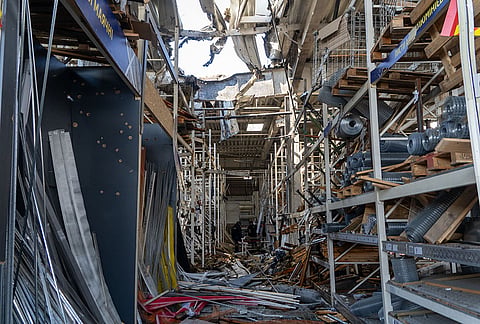 Police officers inspect a commercial facility damaged in a Russian drone attack in Kharkiv, Ukraine, Thursday, Sept. 17, 2026. 