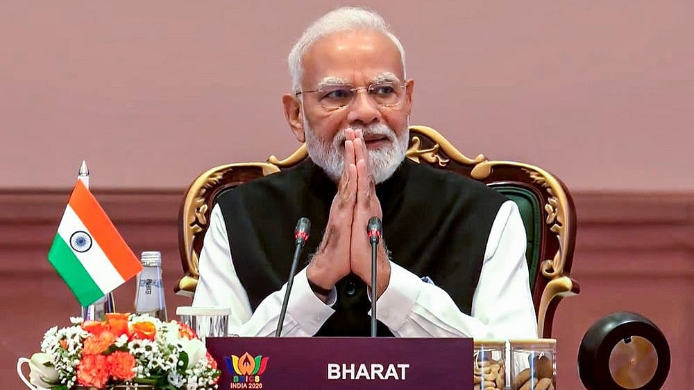 Prime Minister Narendra Modi greets the gathering during the 18th BRICS Summit, at the Bharat Mandapam, in New Delhi.  - | Photo: @NarendraModi/YT via PTI