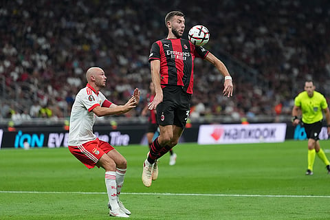 AC Milan's Strahinja Pavlovic controls the ball during the Europa League opening phase soccer match between AC Milan and Benfica in Milan, Italy.