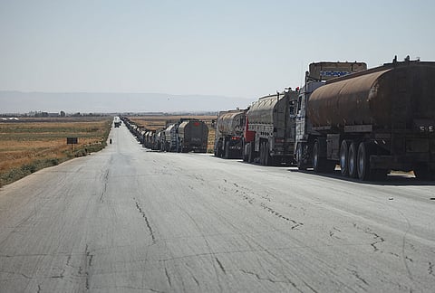 Oil tankers from the Rmeilan oil fields are backed up along a road after being stopped by local residents during ongoing protests against higher fuel prices near Tal Tamr in northeastern Syria, Wednesday, Sept. 16, 2026. 