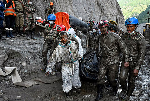 Nepal Army personnel recover a body during an ongoing joint and rescue operation from the tunnel of Chilime Hydropower Project following the devastating flash floods, in Rasuwa district, Nepal. 