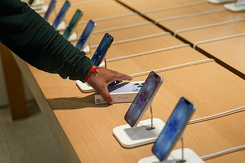 A customer checks the products inside an Apple Store at Select Citywalk Mall during the official sales launch of the iPhone 18 Pro and iPhone 18 Pro Max, in New Delhi.