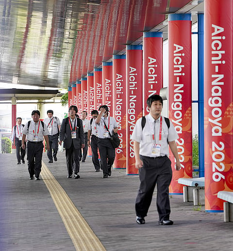 People walk past the media center set up for the Asian Games, at Nagoya Port, Japan, Thursday, Sept. 17, 2026. 