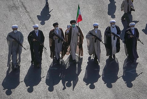Shiite clerics carrying rifles march during the state-organized "Janfada," or "Sacrifice for Iran," military-style parade at Revolution Square in Tehran, Iran, Friday, Sept. 18, 2026. 
