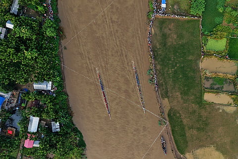 Participants take part in the traditional boat race on the Kulsi river in Champupara village, west of Guwahati, India.