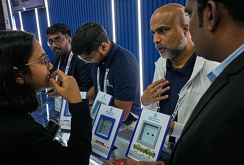 A Tata Electronics exhibitor explains the applications of the company's semiconductor chips to a delegate at Semicon India 2026 in New Delhi, India, Friday, Sept. 18, 2026. 
