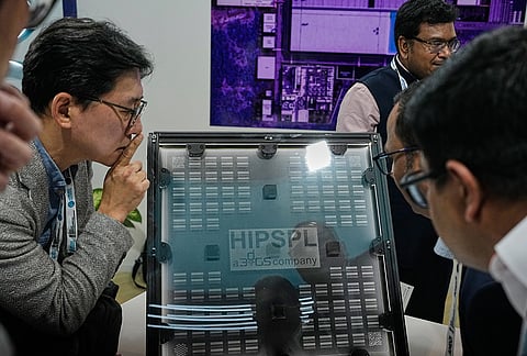 Delegates view a glass interposer for advance packaging at an exhibition showcasing semiconductor technologies at Semicon India 2026 in New Delhi, India, Friday, Sept. 18, 2026. 
