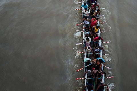 Participants take part in the traditional boat race on the Kulsi river in Champupara village, west of Guwahati, India.