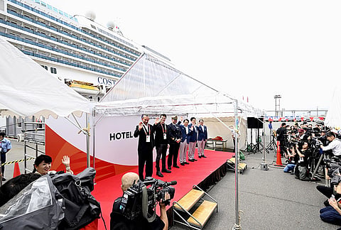 The ceremony for the Italian cruise ship, the Costa Serena, that will house up to 5,000 officials and athletes for the Asian Games, seen at background, is held upon the arrival at a port in Nagoya, central Japan, Tuesday, Sept. 15, 2026. 