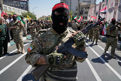 Masked armed personnel affiliated with Iran's Revolutionary Guard carry rifles as they march during the state-organized "Janfada," or "Sacrifice for Iran," military-style parade in Tehran, Iran, Friday, Sept. 18, 2026. 