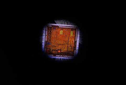 A semiconductor die with wire bonds is seen through a microscope during an exhibition showcasing semiconductor technologies at Semicon India 2026 in New Delhi, India, Friday, Sept. 18, 2026.
