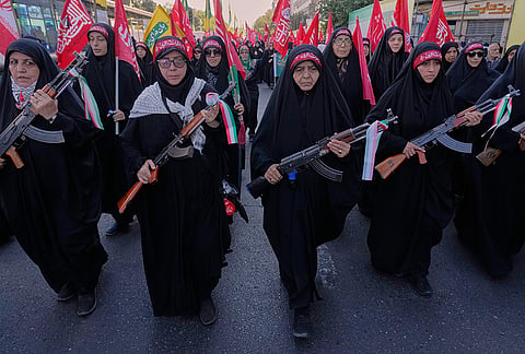 Women affiliated with Iran's Revolutionary Guard carry rifles as they participate in the state-organized "Janfada," or "Sacrifice for Iran," military-style parade in Tehran, Iran, Friday, Sept. 18, 2026. 
