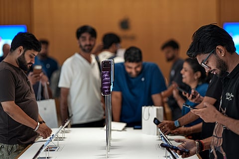 Customers check products inside the Apple Store at Select Citywalk Mall during the official sales launch of the iPhone 18 Pro and iPhone 18 Pro Max, in New Delhi.