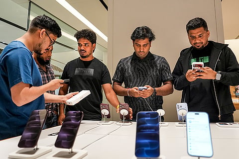 Customers check products at an Apple store during the official sales launch of the iPhone 18 Pro and iPhone 18 Pro Max, in Bengaluru, Karnataka.