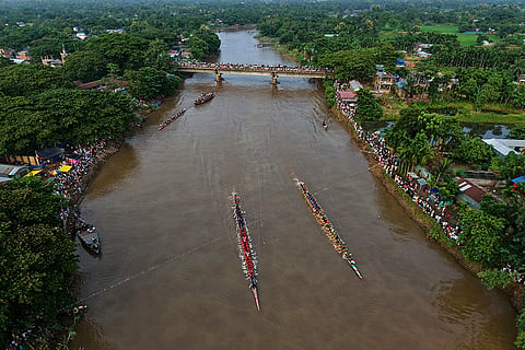 Participants take part in the traditional boat race on the Kulsi river in Champupara village, west of Guwahati, India.