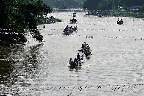 Participants take part in the traditional boat race on the Kulsi river in Champupara village, west of Guwahati, India.