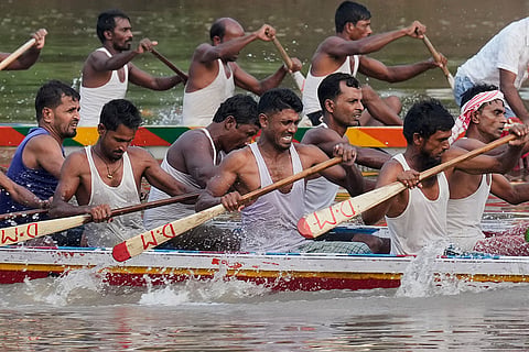 Participants take part in the traditional boat race on the Kulsi river in Champupara village, west of Guwahati, India.