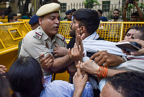 ABVP activists clash with a police official during a protest, amid voting in the Delhi University Students Union (DUSU) elections, at Law Centre-I, Faculty of Law, in New Delhi, Friday, Sept. 18, 2026. 
